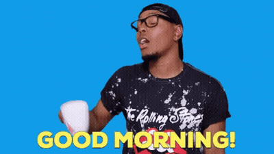 A Man Wearing A Rolling Stones Shirt Is Holding A Cup In His Hand And Says Good Morning GIF