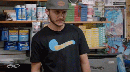 A Man Wearing A Rvca Hat And A T-Shirt With A Wave On It GIF