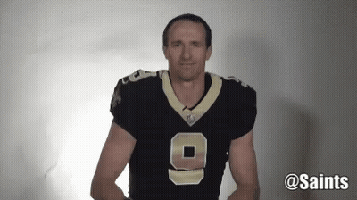 A Man Wearing A Saints Jersey With The Number 9 On It GIF
