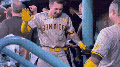 A Man Wearing A San Diego Jersey Stands In The Dugout GIF