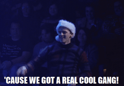 A Man Wearing A Santa Hat Is Standing In Front Of A Crowd And Says ' Cause We Got A Real Cool Gang ' GIF