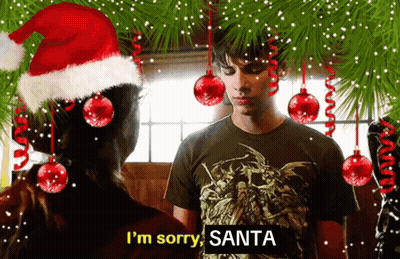 A Man Wearing A Santa Hat Says I 'M Sorry Santa In Front Of A Woman GIF