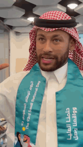 A Man Wearing A Saudi National Day Sash GIF