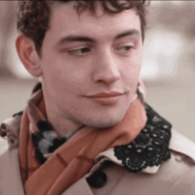 A Man Wearing A Scarf And A Trench Coat With A Lace Collar GIF