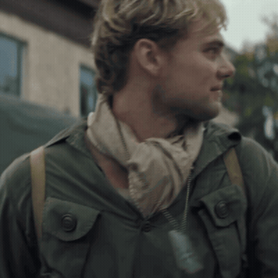 A Man Wearing A Scarf Around His Neck And A Jacket GIF