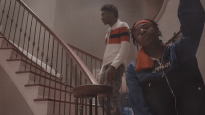 A Man Wearing A Scarf Around His Neck Has The Word Supreme On His Chest GIF