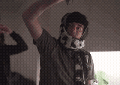 A Man Wearing A Scarf Around His Neck With The Numbers 5 And 3 On It GIF