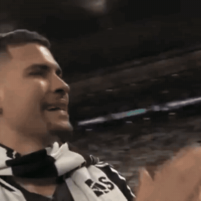 A Man Wearing A Scarf That Says Ras Is Clapping GIF