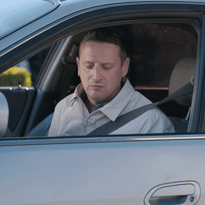 A Man Wearing A Seat Belt Is Sitting In A Car GIF