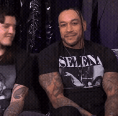 A Man Wearing A Selena T-Shirt Is Smiling GIF
