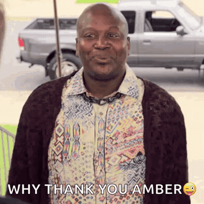 A Man Wearing A Shirt And Tie Is Smiling And Says Why Thank You Amber GIF