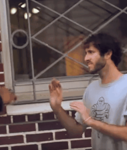 A Man Wearing A Shirt That Has A Ghost On It GIF