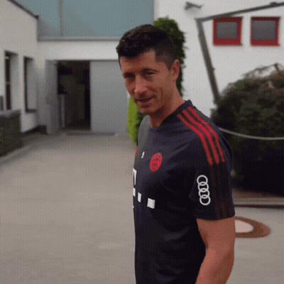 A Man Wearing A Shirt That Has The Word Audi On The Sleeve GIF