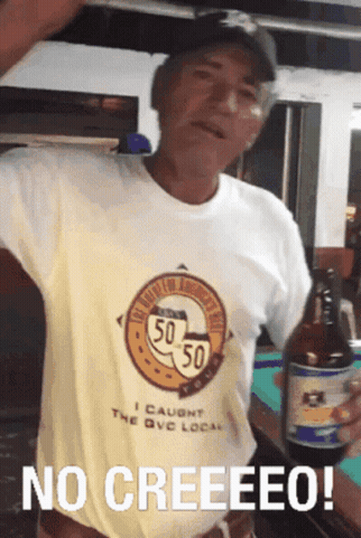 A Man Wearing A Shirt That Says 50 50 Is Holding A Beer Bottle GIF