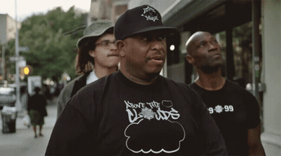 A Man Wearing A Shirt That Says Above The Clouds On It GIF