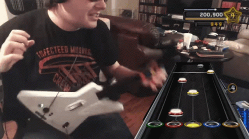 A Man Wearing A Shirt That Says " Affected Musicians " Is Playing A Guitar Game GIF