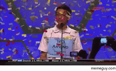 A Man Wearing A Shirt That Says Arvind Is Standing In Front Of A Microphone GIF