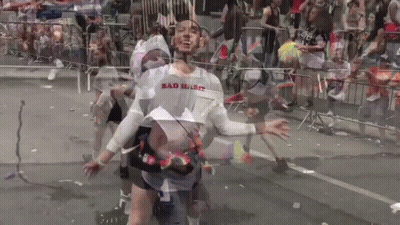 A Man Wearing A Shirt That Says Bad Habit Is Dancing In Front Of A Crowd GIF