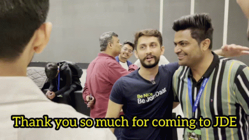 A Man Wearing A Shirt That Says Be Nice Be Jordan Is Surrounded By Other Men GIF