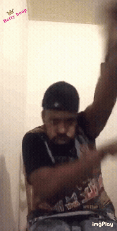 A Man Wearing A Shirt That Says Betty Boop Is Dancing GIF
