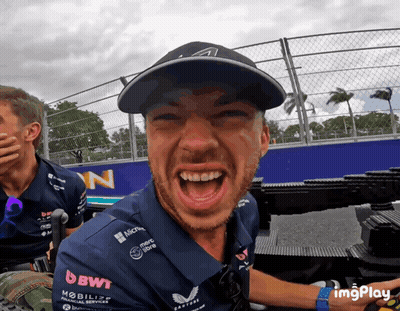 A Man Wearing A Shirt That Says Bwt On It Is Laughing GIF