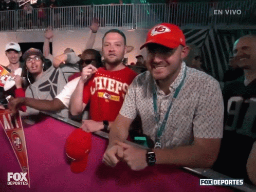 A Man Wearing A Shirt That Says Chiefs Stands In A Crowd GIF