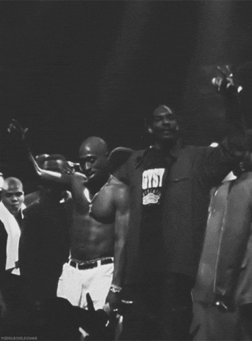 A Man Wearing A Shirt That Says Cyst Stands In A Crowd GIF