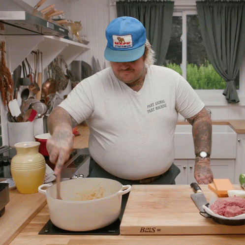 A Man Wearing A Shirt That Says Dirty Animal Party Machine Stirs A Pot GIF