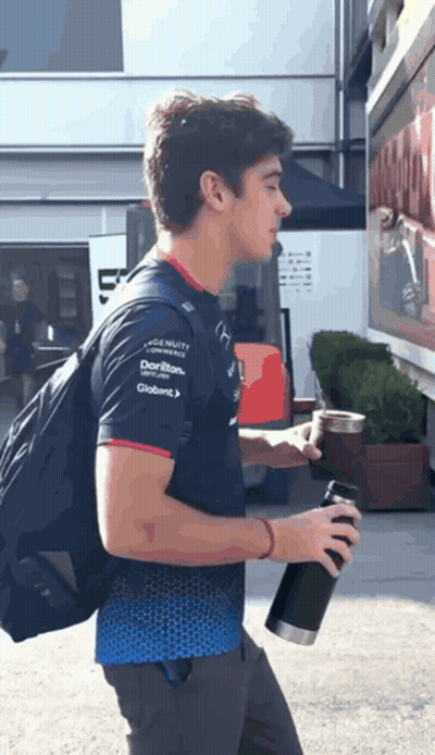 A Man Wearing A Shirt That Says ' Dorito ' On The Sleeve GIF