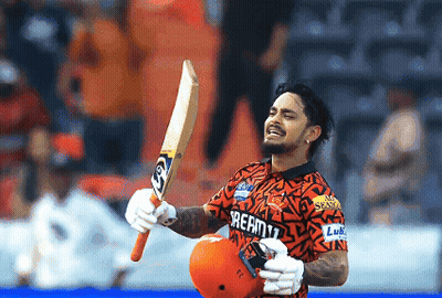 A Man Wearing A Shirt That Says Dream11 Holds Up A Bat GIF