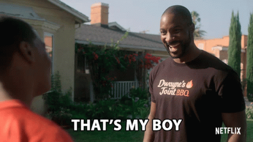 A Man Wearing A Shirt That Says Duwayne 'S Joint Bbq Is Talking To Another Man GIF