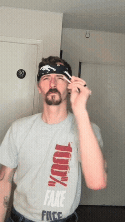 A Man Wearing A Shirt That Says Fake Free GIF