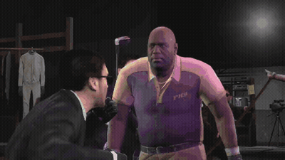 A Man Wearing A Shirt That Says Fhs Shakes Hands With Another Man In A Suit GIF