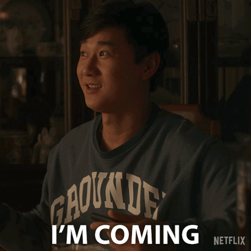 A Man Wearing A Shirt That Says Gaounde On It Says I 'M Coming GIF
