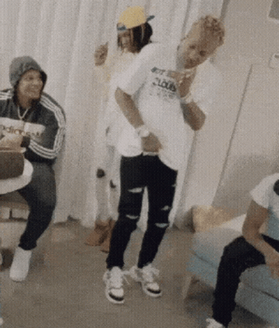 A Man Wearing A Shirt That Says Get Loud Is Dancing In A Room GIF