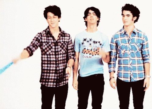A Man Wearing A Shirt That Says Guam Is Standing Next To Two Other Men GIF