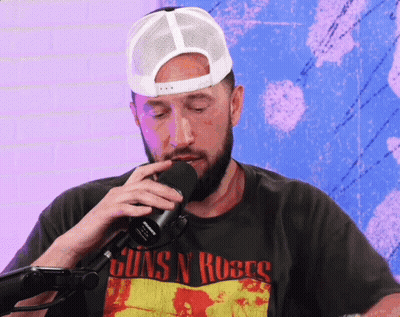 A Man Wearing A Shirt That Says Guns N Roses On It GIF