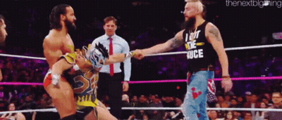 A Man Wearing A Shirt That Says I Got The Juice Shakes Hands With Another Man In A Wrestling Ring GIF