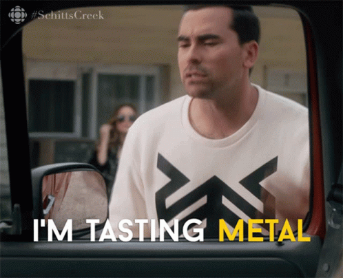 A Man Wearing A Shirt That Says I 'M Tasting Metal Looks Out Of A Car Window GIF