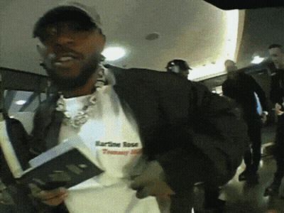 A Man Wearing A Shirt That Says Karline Rose GIF