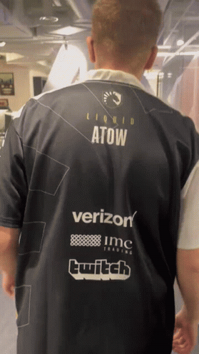 A Man Wearing A Shirt That Says Liquid Atow On The Back GIF