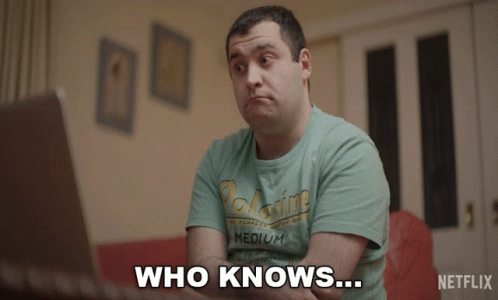A Man Wearing A Shirt That Says Medium Is Sitting In Front Of A Laptop And Says " Who Knows " GIF