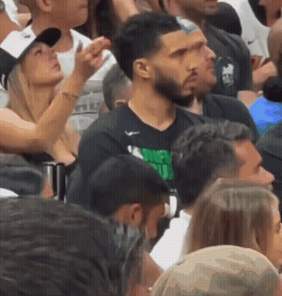 A Man Wearing A Shirt That Says Money Club Is Surrounded By Other People GIF