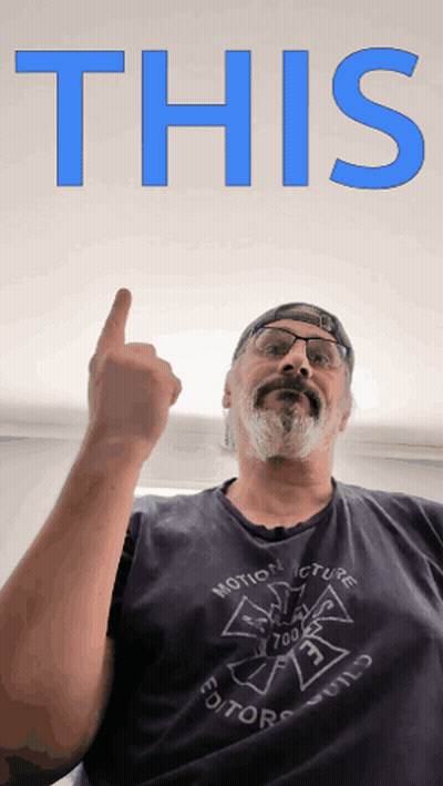 A Man Wearing A Shirt That Says Motion Picture Editor Holds His Finger Up GIF