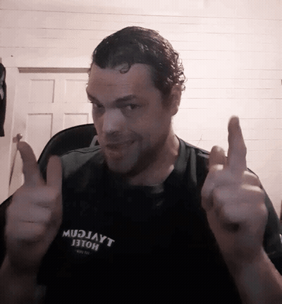 A Man Wearing A Shirt That Says Mudjayt Giving A Thumbs Up GIF