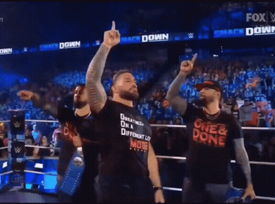 A Man Wearing A Shirt That Says One & Done Is Standing In Front Of A Crowd GIF
