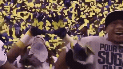 A Man Wearing A Shirt That Says Pour Sugar On It Stands In Front Of A Crowd Of People GIF