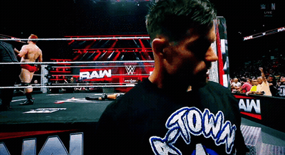 A Man Wearing A Shirt That Says Raw On It GIF