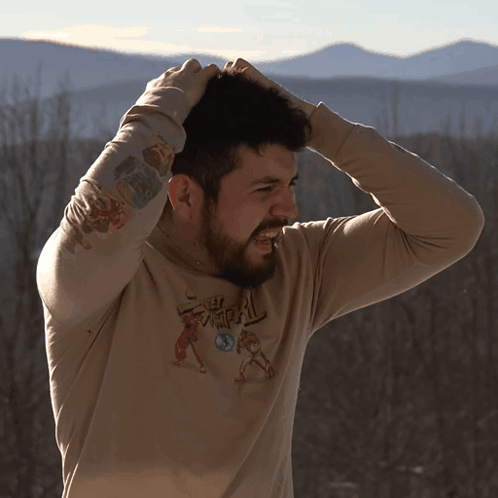 A Man Wearing A Shirt That Says Samurai Holds His Head GIF