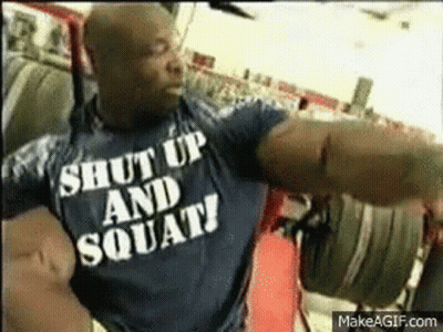 A Man Wearing A Shirt That Says Shut Up And Squats GIF